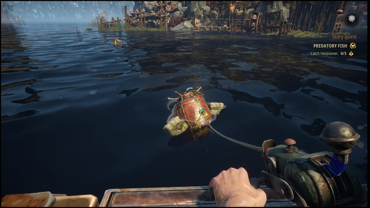 A cable-linked tool pulls floating red cargo toward the boat.